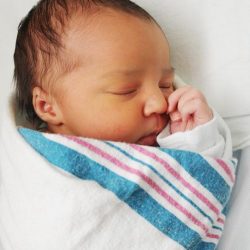 Newborn,Infant,Baby,Sleeping,Wrapped,In,Blanket